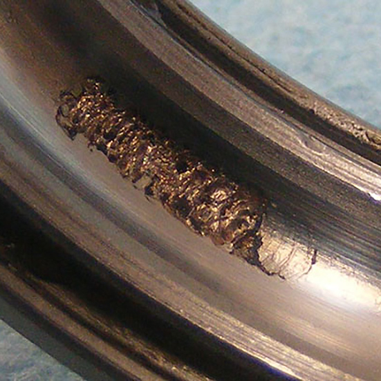 Flaking on a ball bearing outer ring raceway