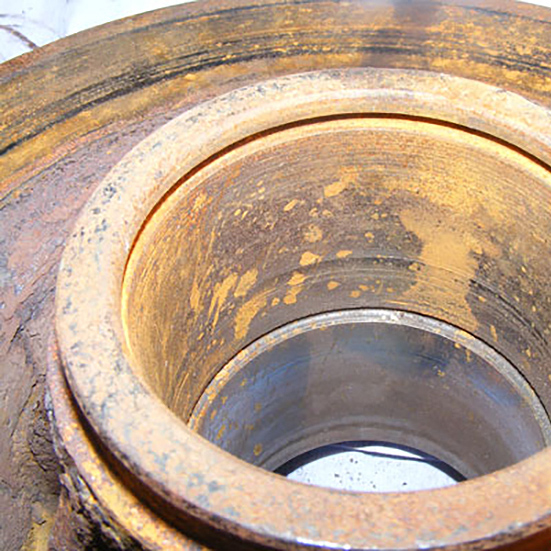 A wheel hub with a damaged abutment shoulder, a worn and tapered housing bore and excessive corrosion due to the environment the bearings were used in